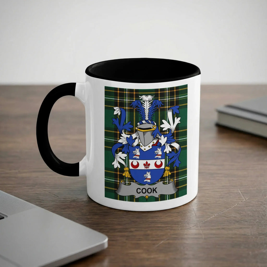 White mug with black rim featuring the Cook family crest on a plaid background.