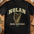 Nolan Irish harp T-shirt in Black, with cream surname lettering, a gold-toned harp, green shamrock and “Irish Heritage” text.