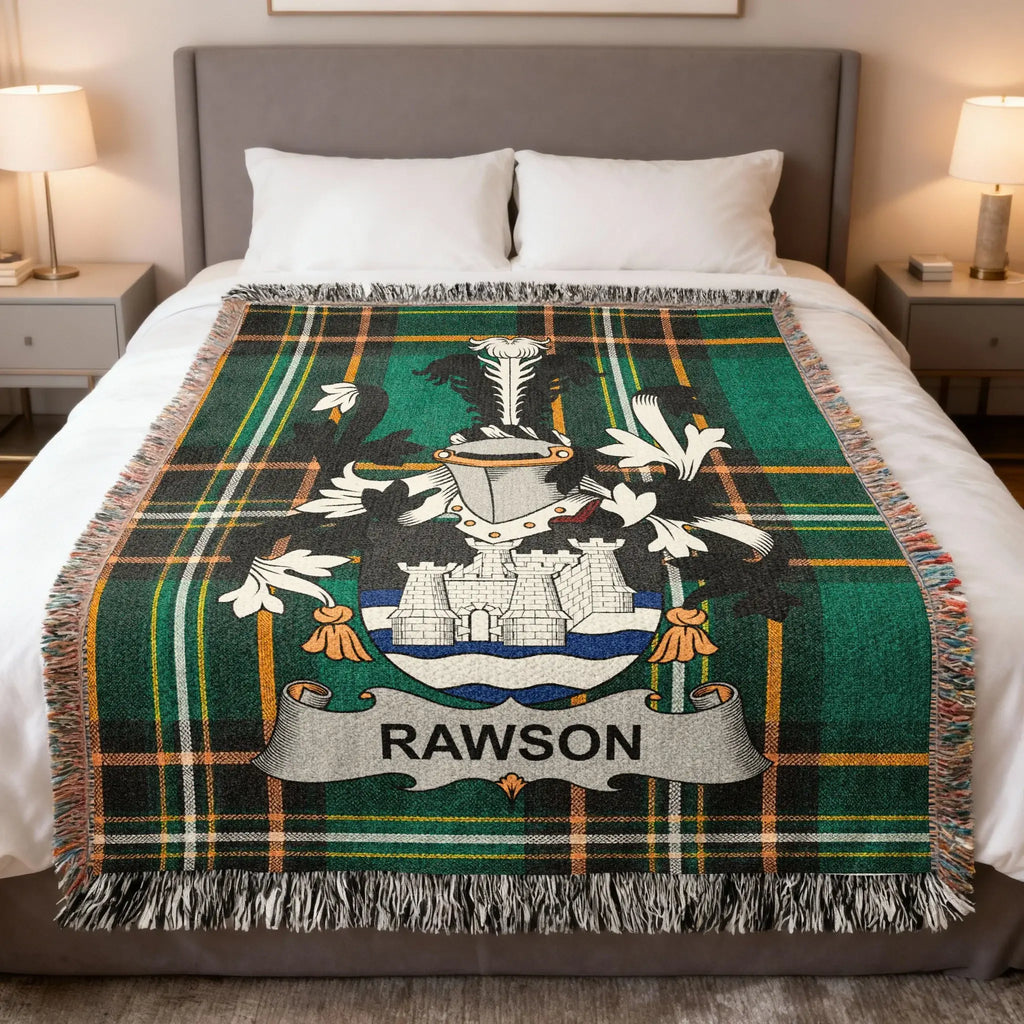 Tartan blanket with Rawson crest draped over a bed.
