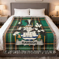 Tartan blanket with Rawson crest draped over a bed.