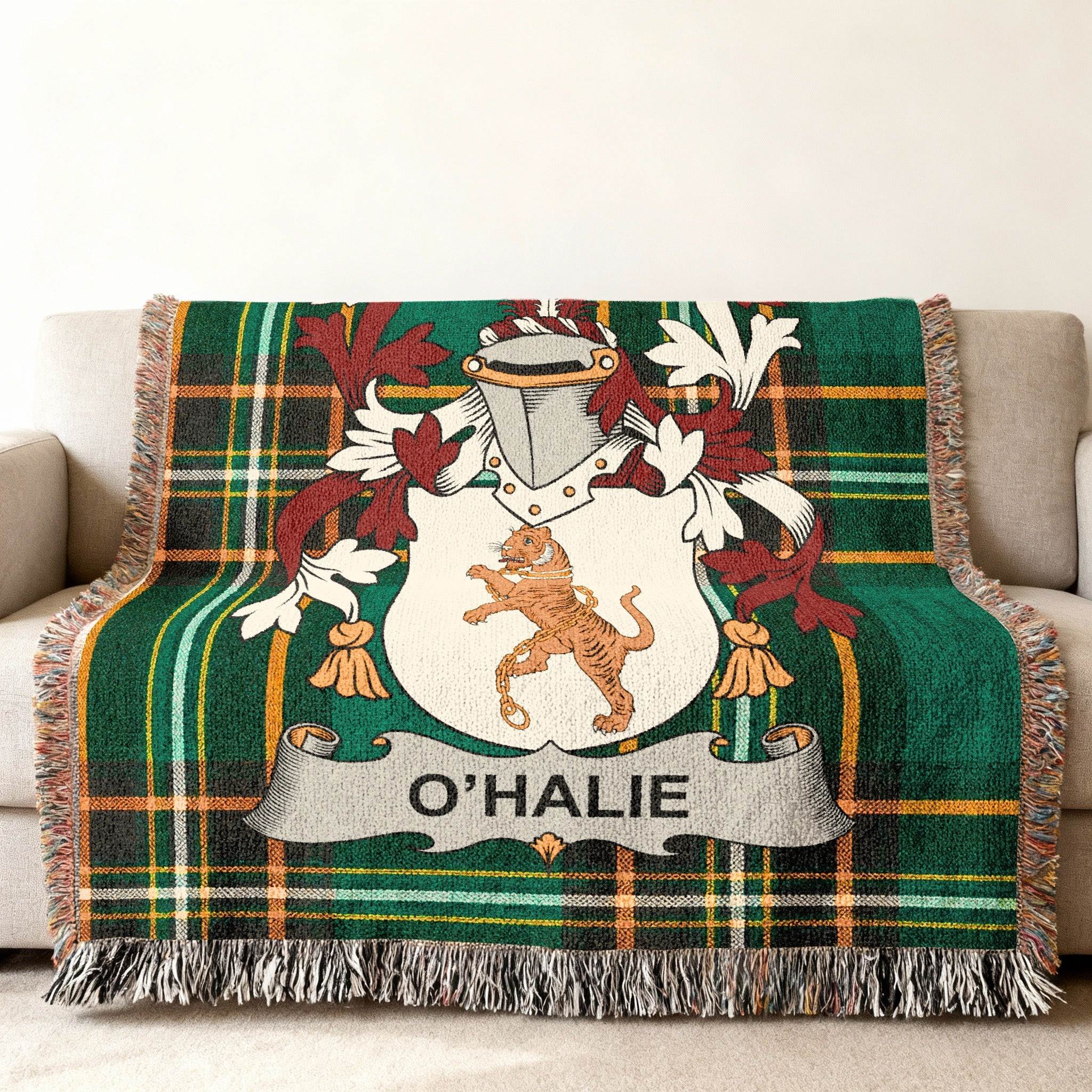 O'HALIE crest on a green plaid throw blanket with fringe.