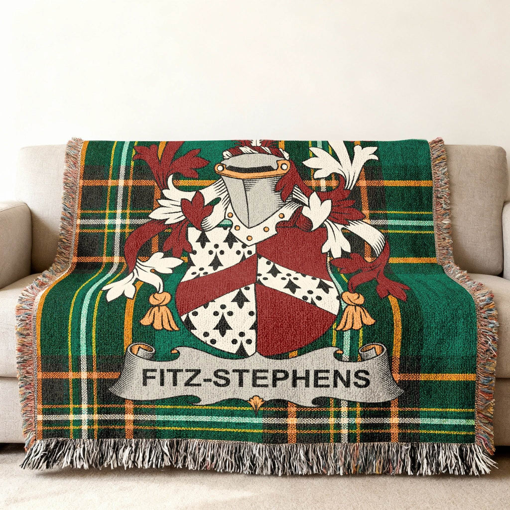 Tartan blanket with Fitz-Stephens coat of arms on a sofa.