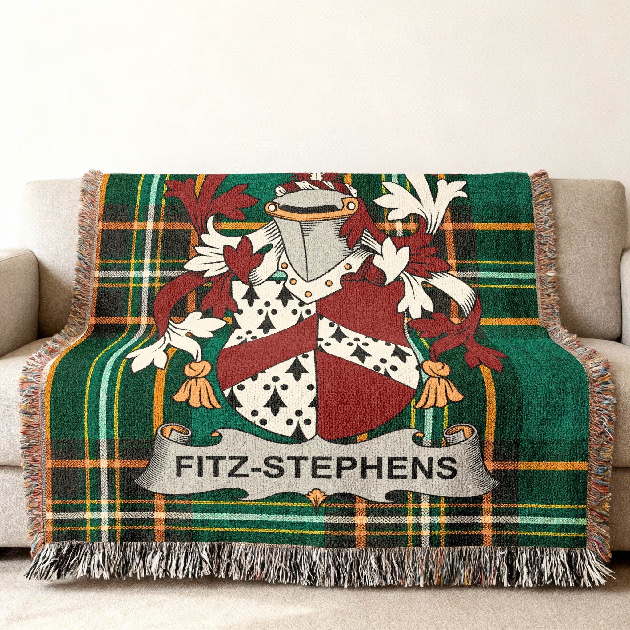 Tartan blanket with Fitz-Stephens coat of arms on a sofa.
