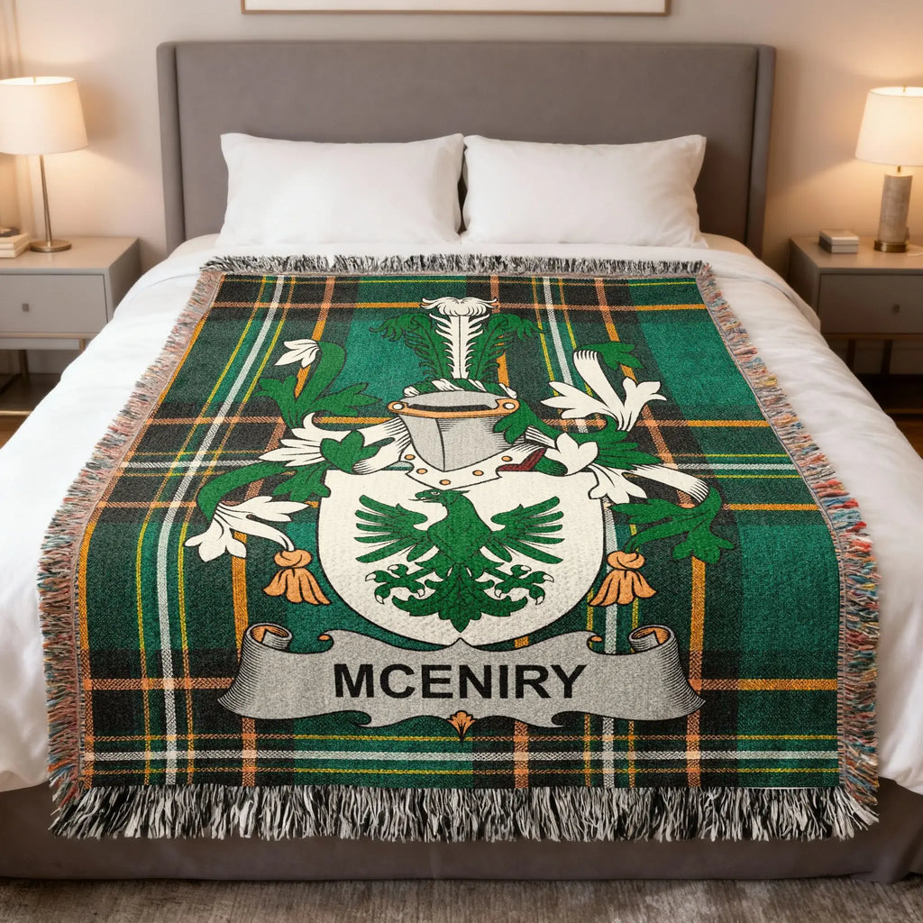 McINIRY family crest on a green plaid woven blanket on a bed.