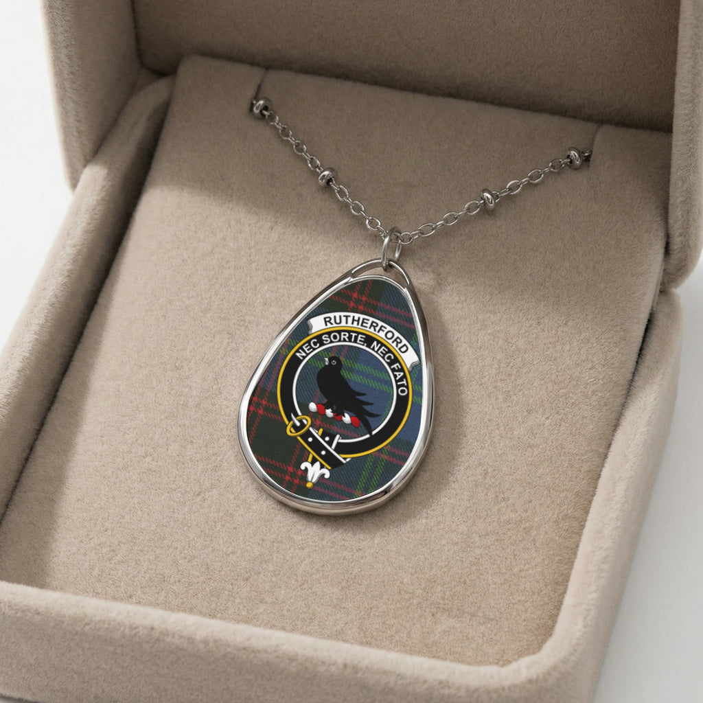 Rutherford clan crest necklace with tach and Latin motto on tartan background.