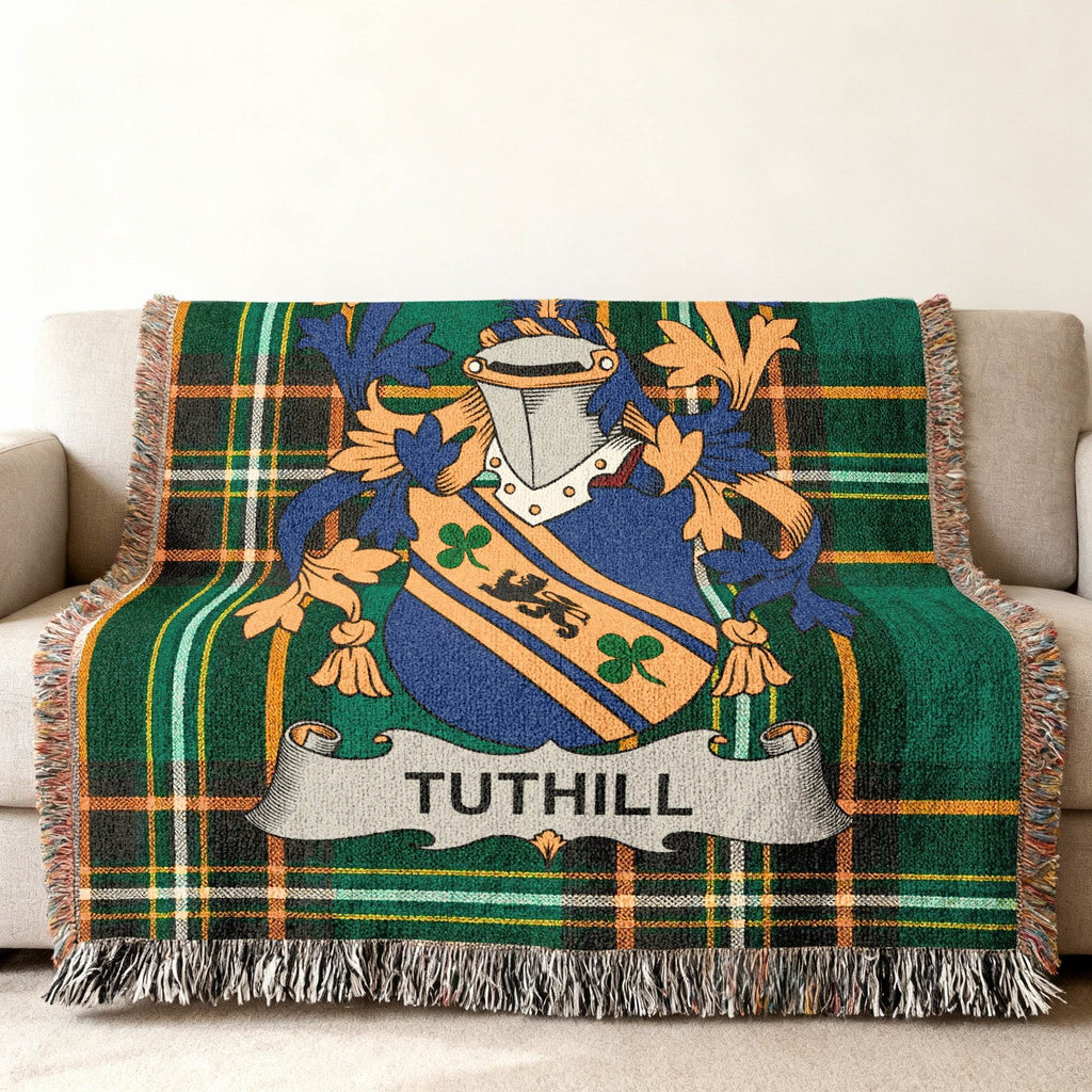 Tuthill family crest on a green tartan throw blanket.