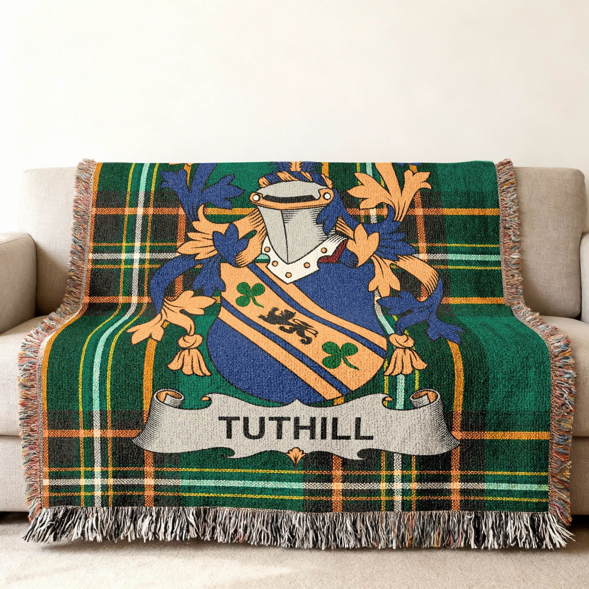 Tuthill family crest on a green tartan throw blanket.