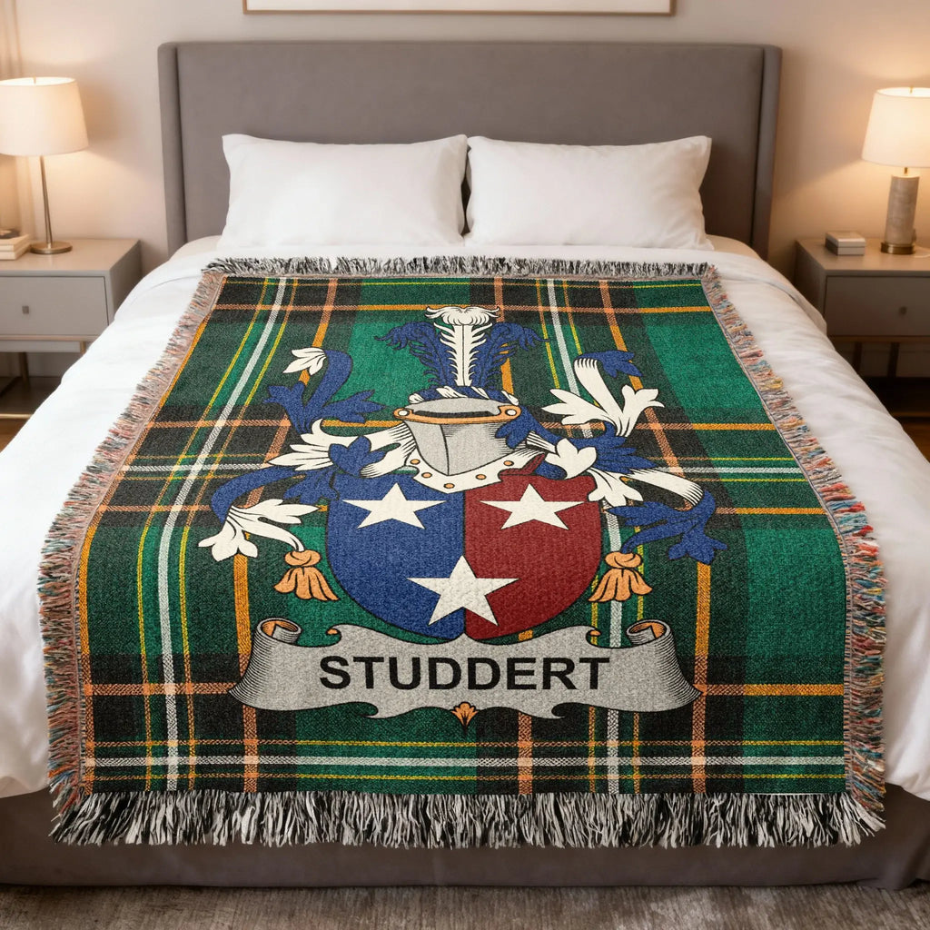 Tartan blanket with Studdert family crest in blue, white, and red.