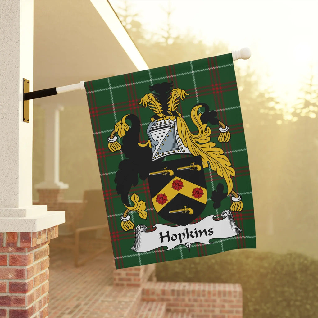 Green plaid flag with Hopkins crest and banner, displayed on a porch.