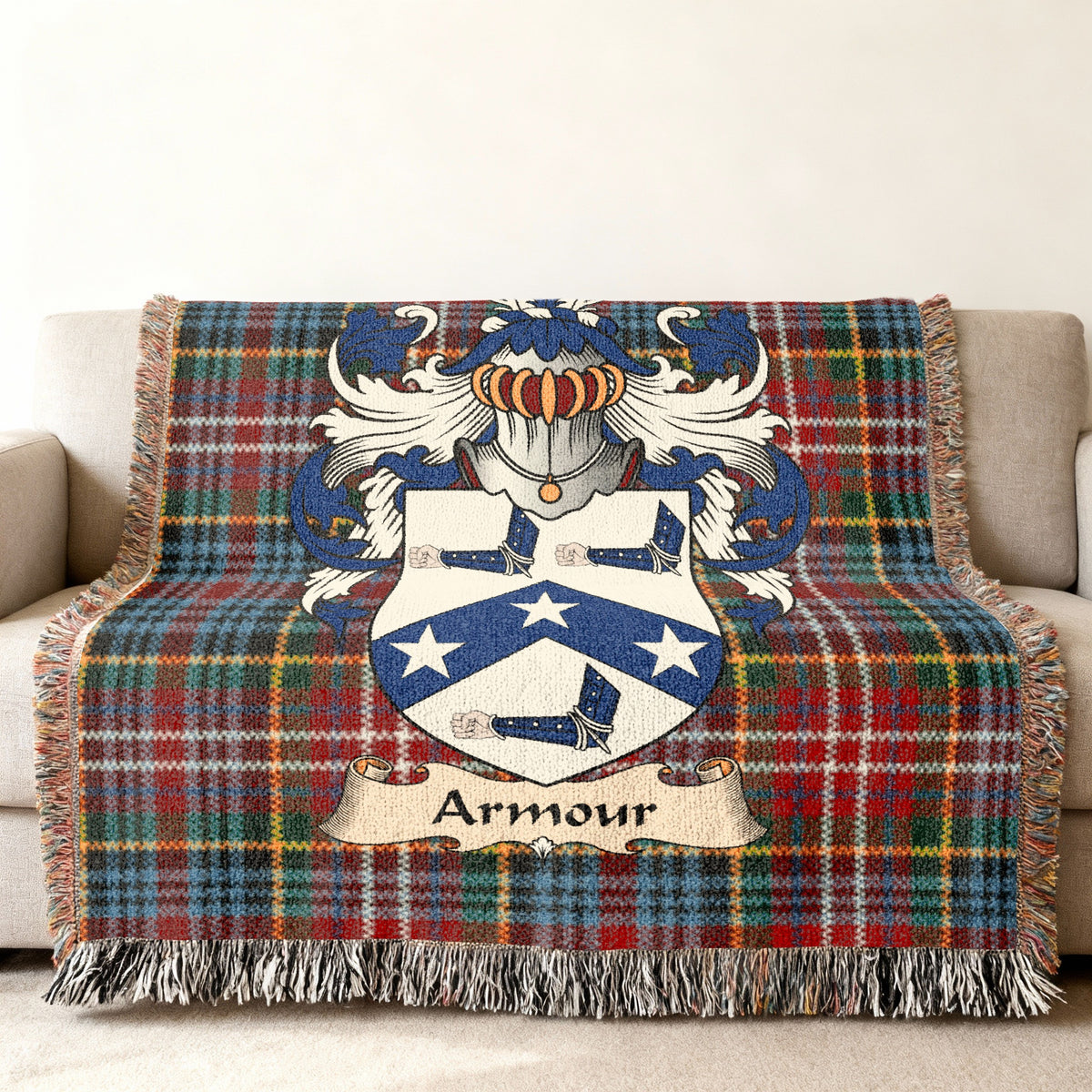 Armour Scottish family shield woven blanket with Caledonia tartan background on a sofa