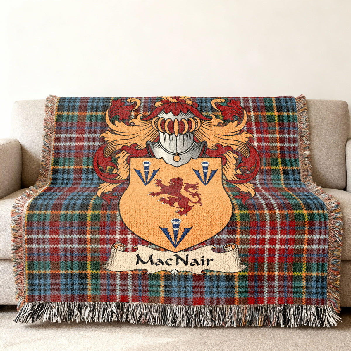 MacNair family crest emblem on a Caledonia tartan woven blanket