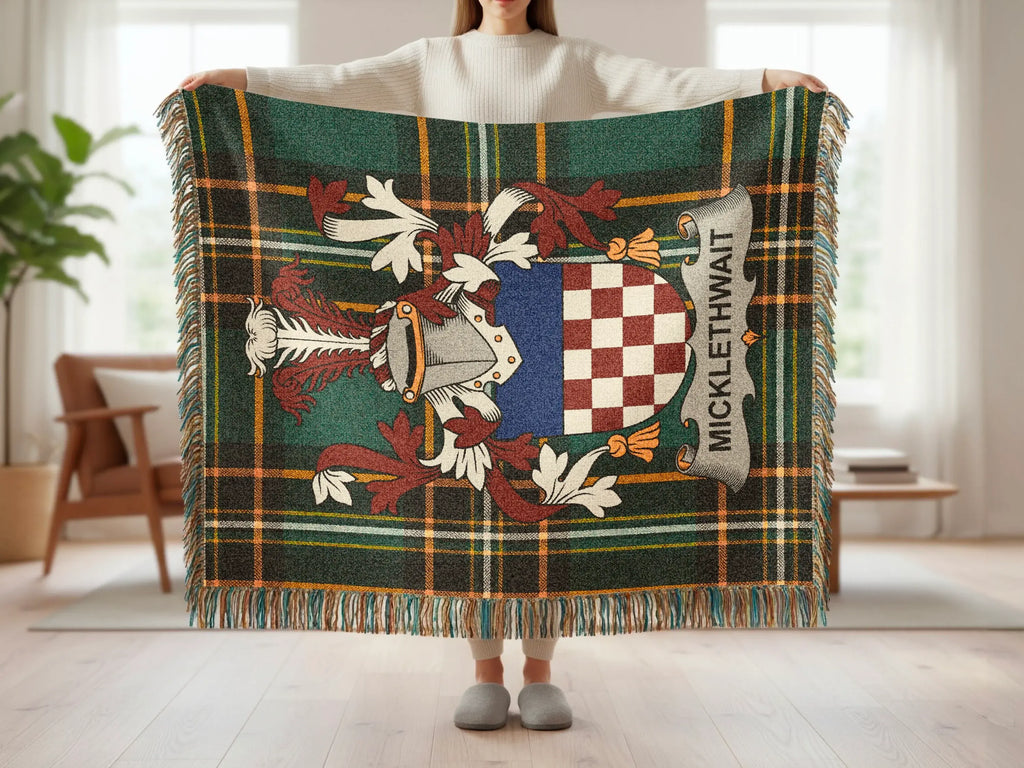 Tartan blanket featuring a coat of arms with "MICKLETHWAIT" text.