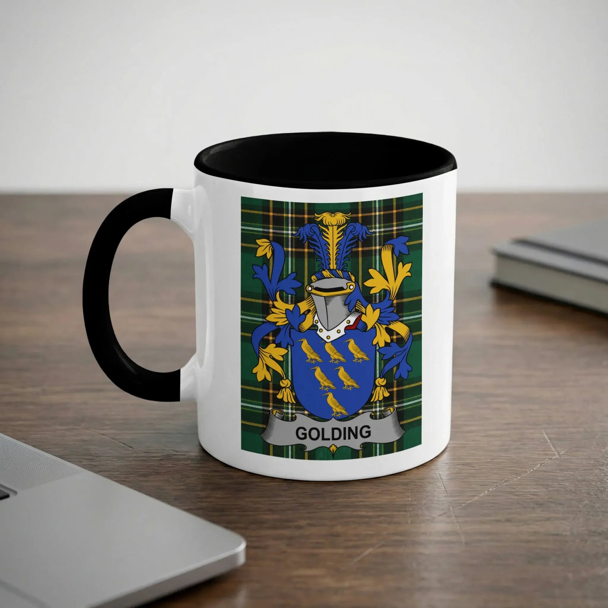 Mug with Golding family crest on a desk.