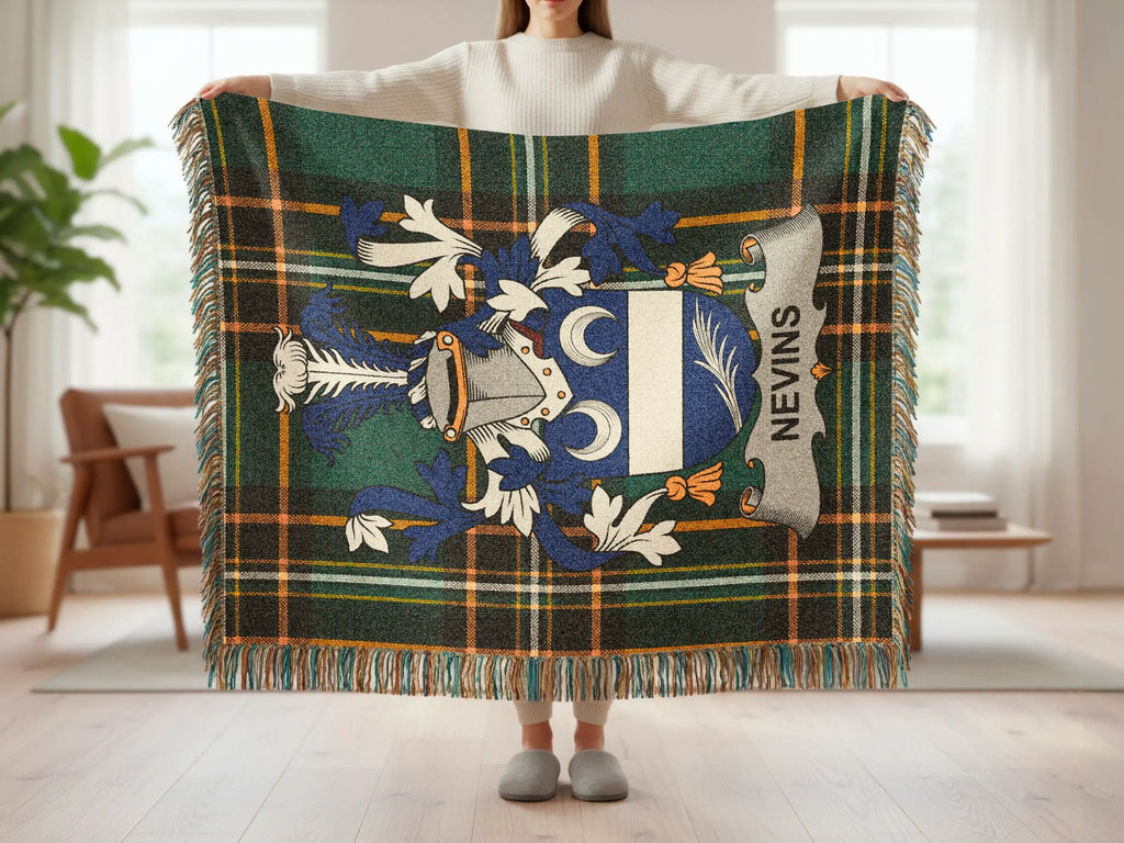 Tartan throw blanket with blue and silver Nevins family crest displayed.