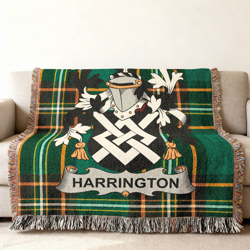 Green plaid blanket with Harrington family crest draped over a sofa.