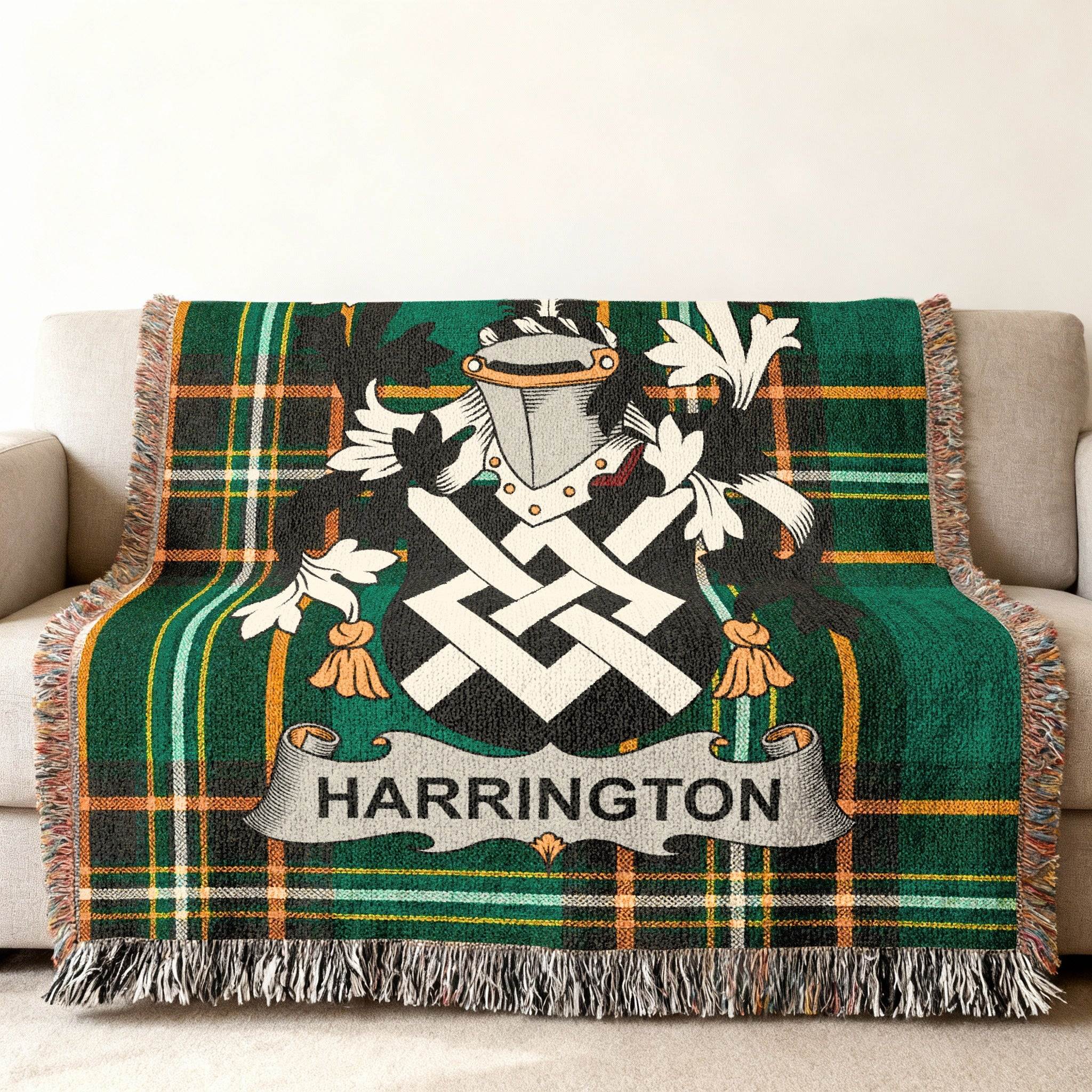 Green plaid blanket with Harrington family crest draped over a sofa.