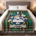 Tartan blanket with a blue and white coat of arms featuring the name "LEMAN".