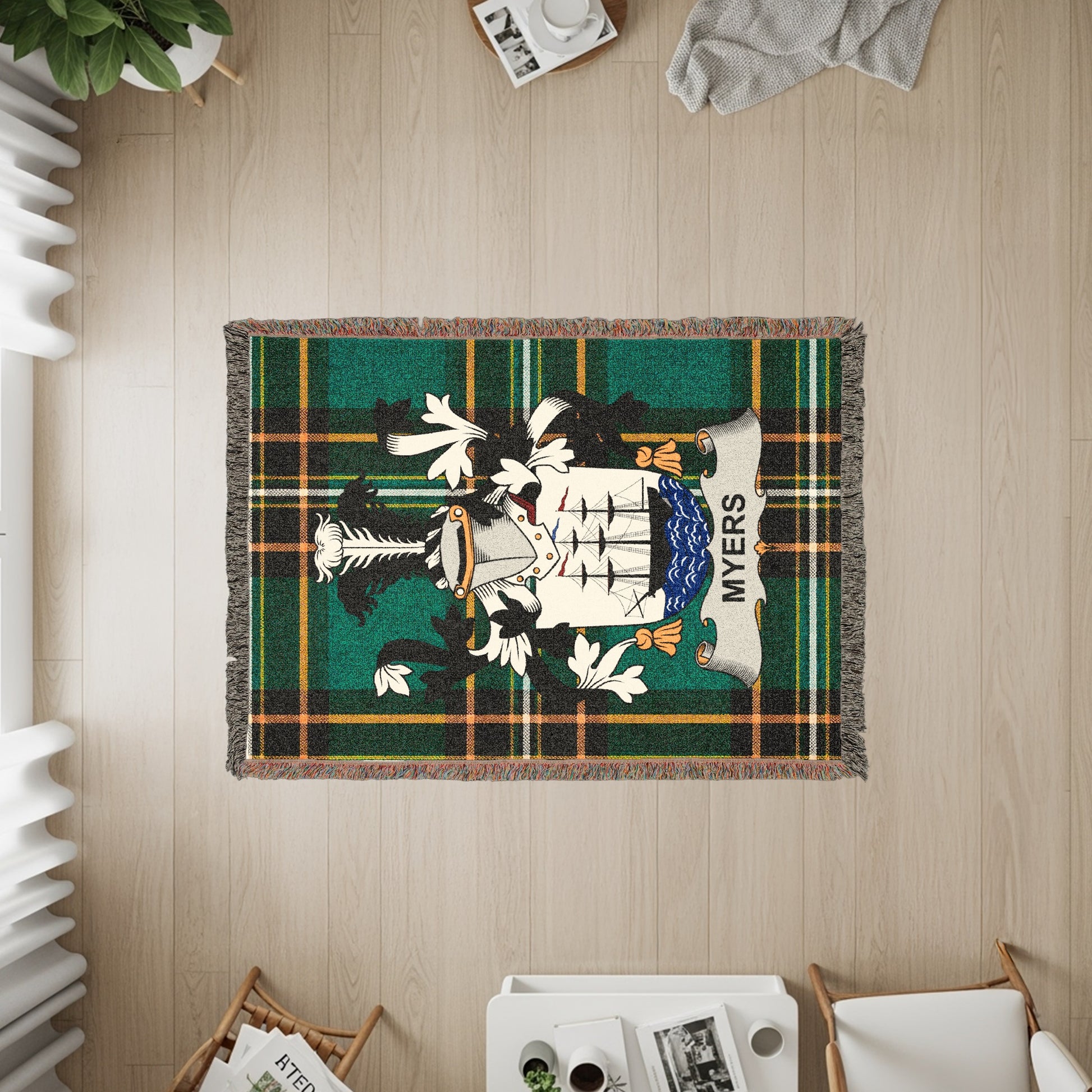 Myers family crest on a green plaid woven blanket with fringe.