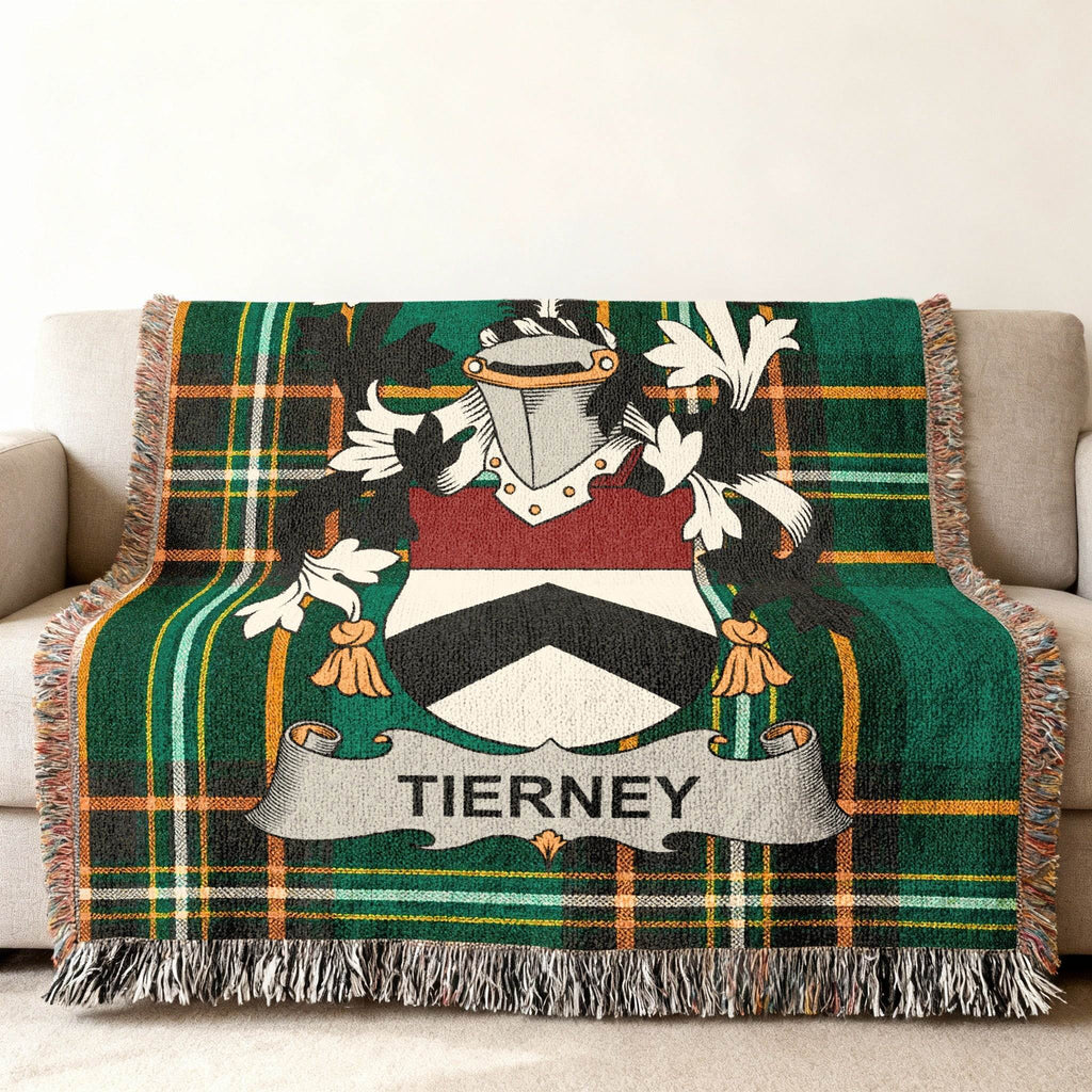 Tierney tartan blanket with crest draped over a sofa.