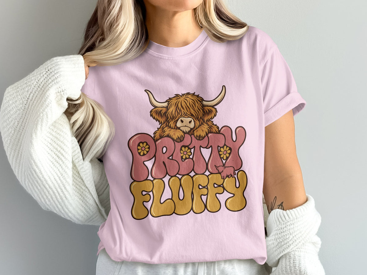 Model wearing the Pretty Fluffy Highland cow Comfort Colors T-shirt in Blossom