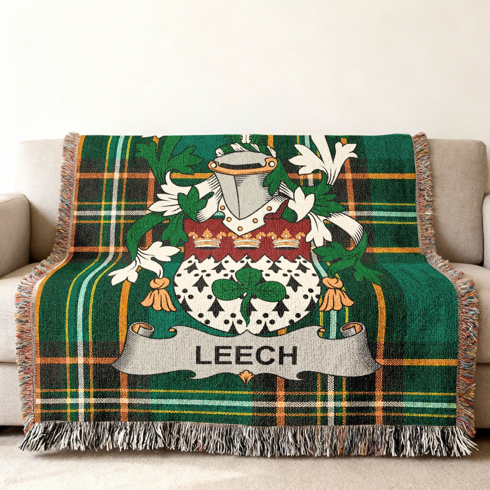 Green plaid throw blanket with Leech family crest.