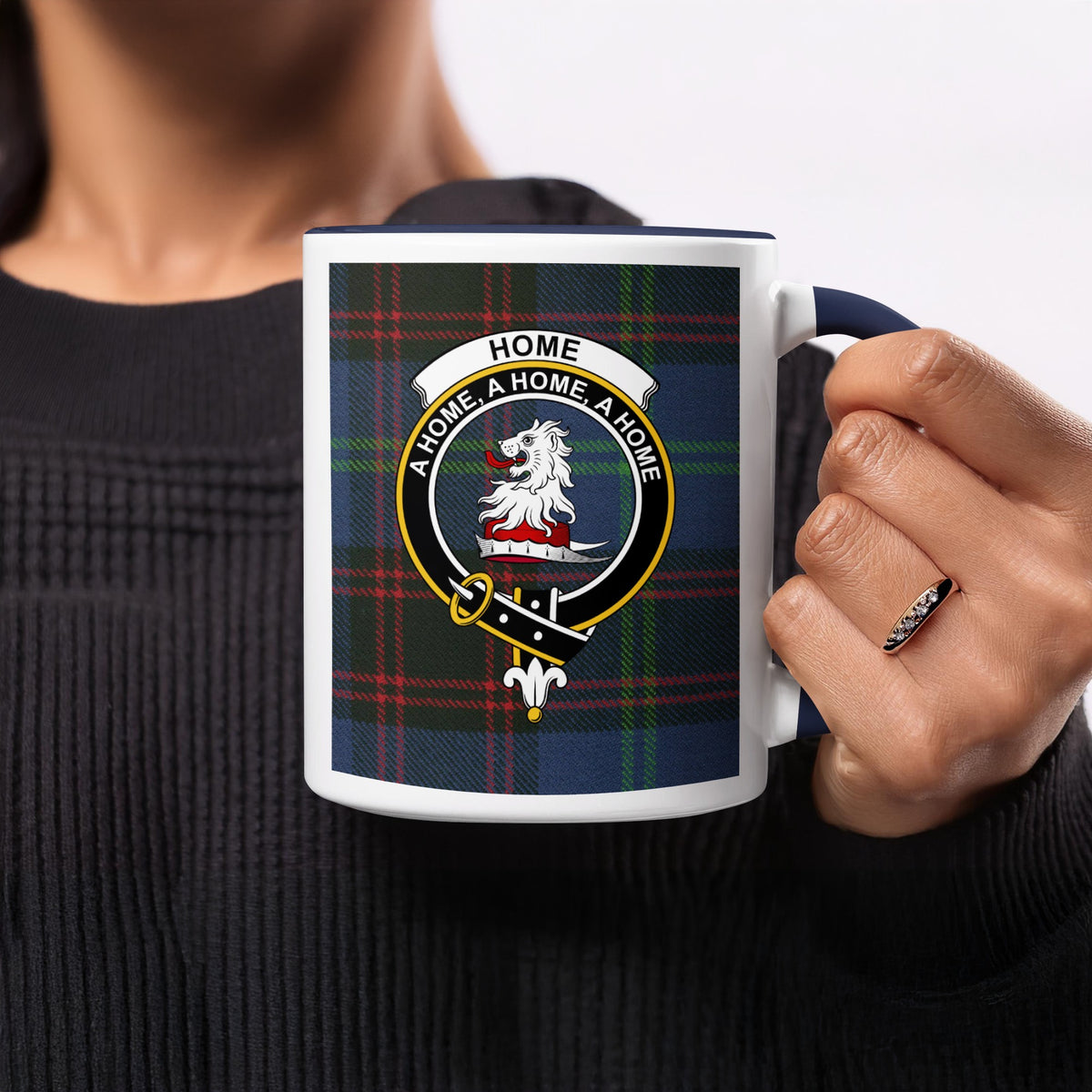 Close-up lifestyle view of Home Scottish clan crest artwork on a navy 11 oz accent mug with a tartan background