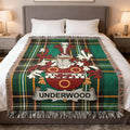 Tartan throw blanket with Underwood family crest centered on a bed.