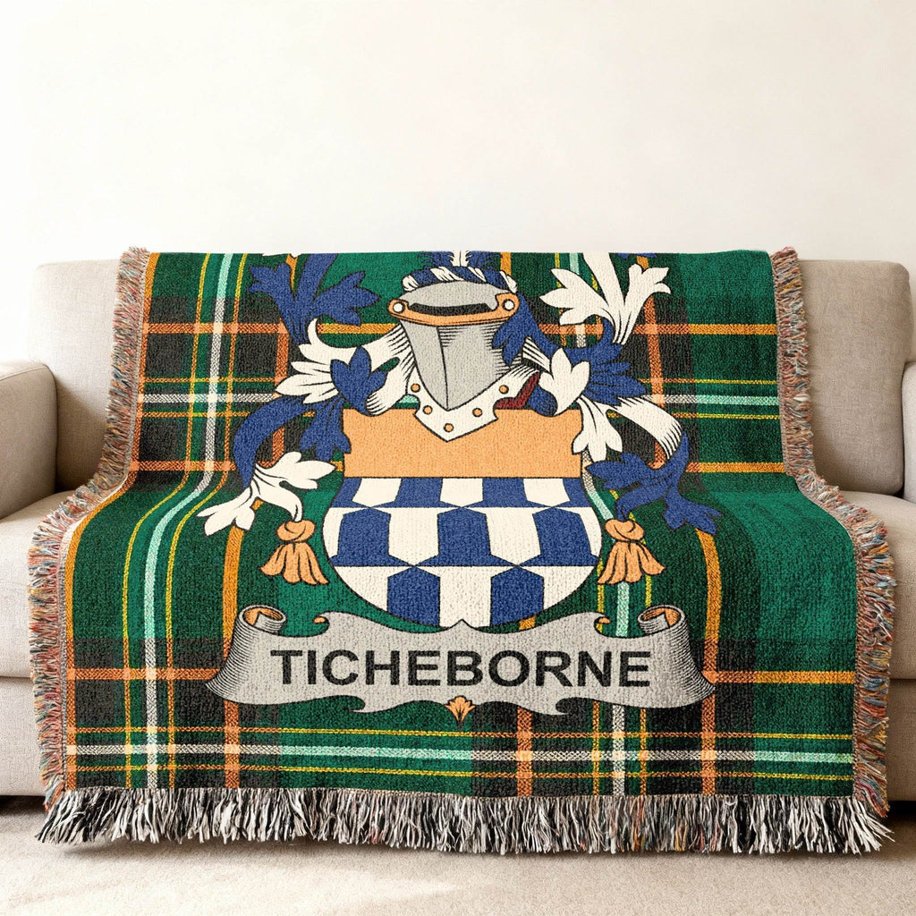 Green plaid throw blanket with a blue and white crest and "TICHEBORNE" text.