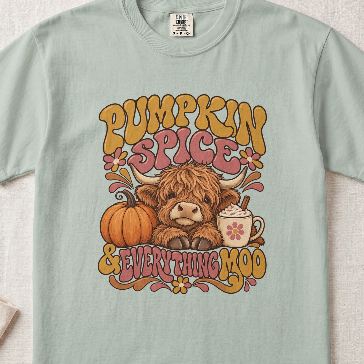 Pumpkin Spice & Everything Moo Highland cow design on a Bay Comfort Colors 1717 T-shirt, flat lay