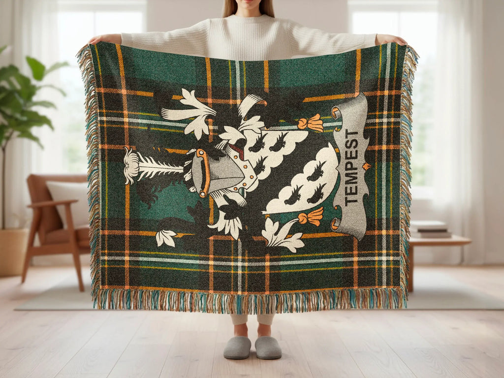 Green plaid blanket with a crest and the word "Tempest" held by a person.