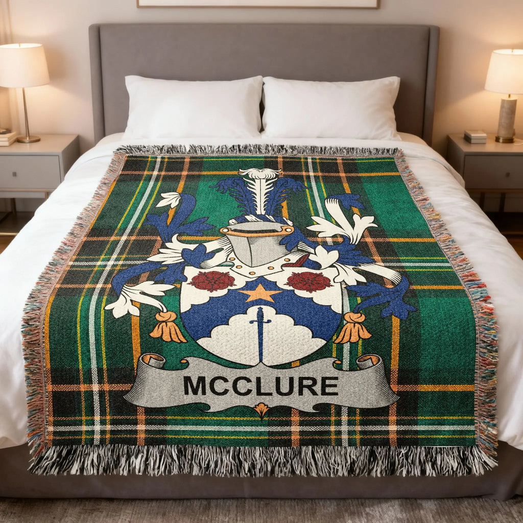McClure family crest on a green tartan blanket with fringe.