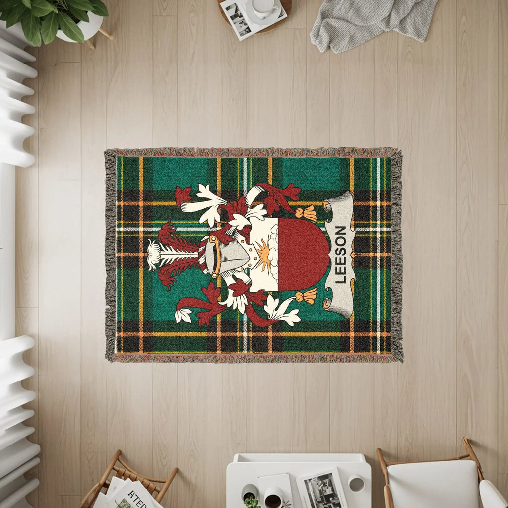 Leeson family crest on a green plaid woven throw blanket.