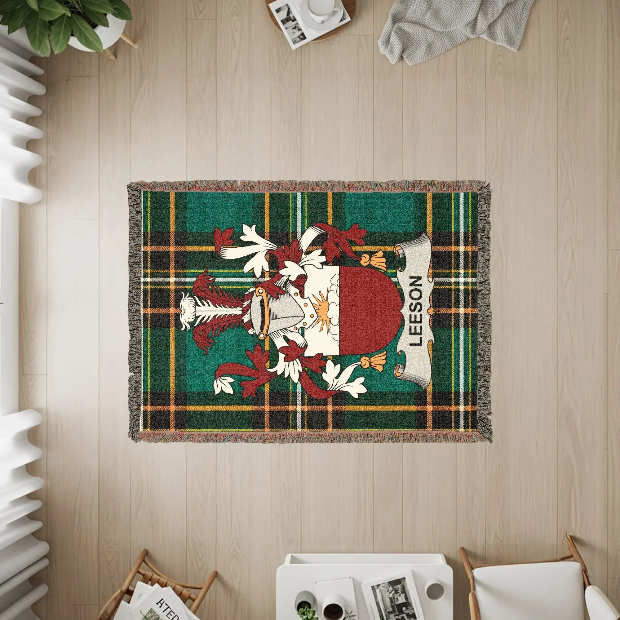Leeson family crest on a green plaid woven throw blanket.