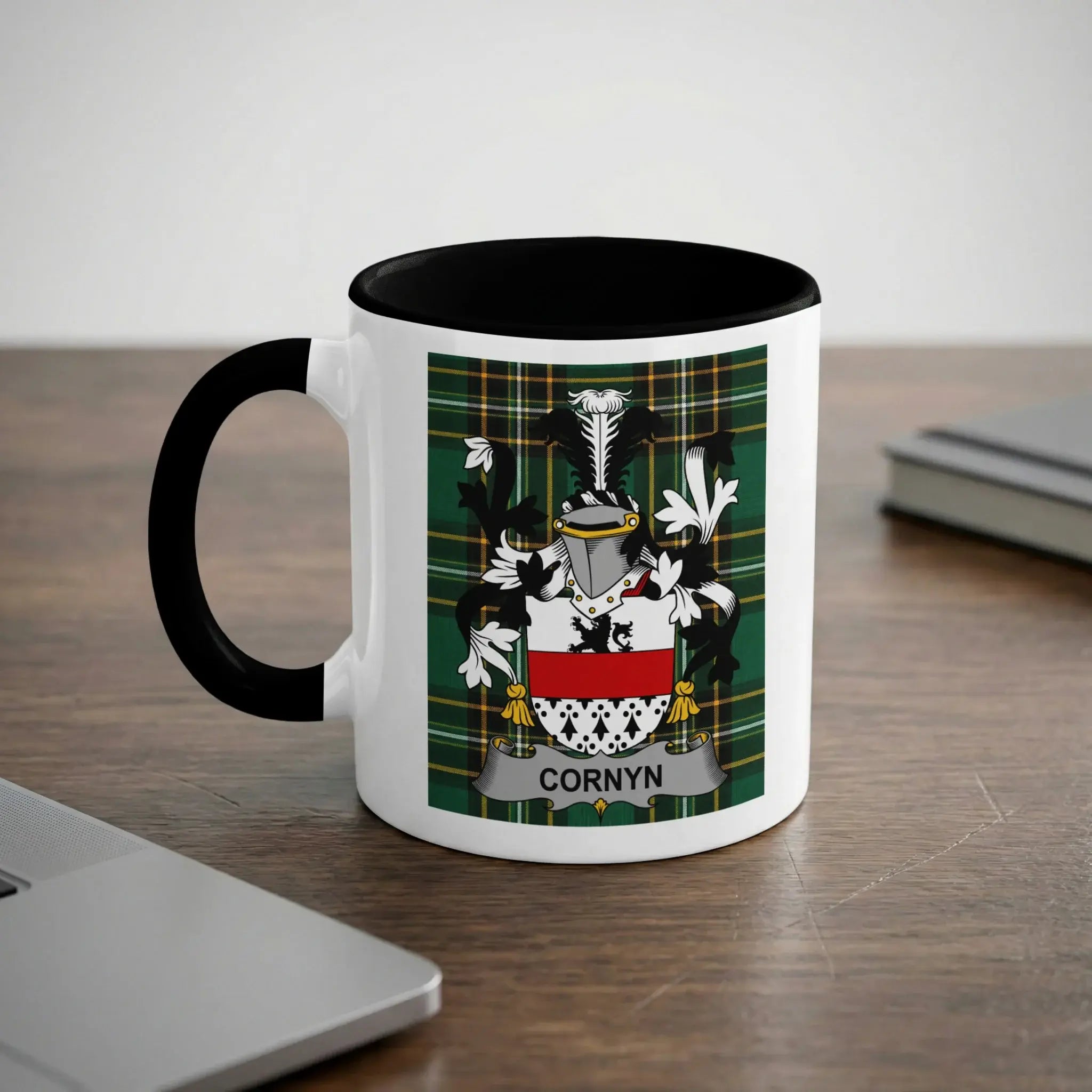 White mug with black rim featuring the CORNYN family crest on a plaid background.
