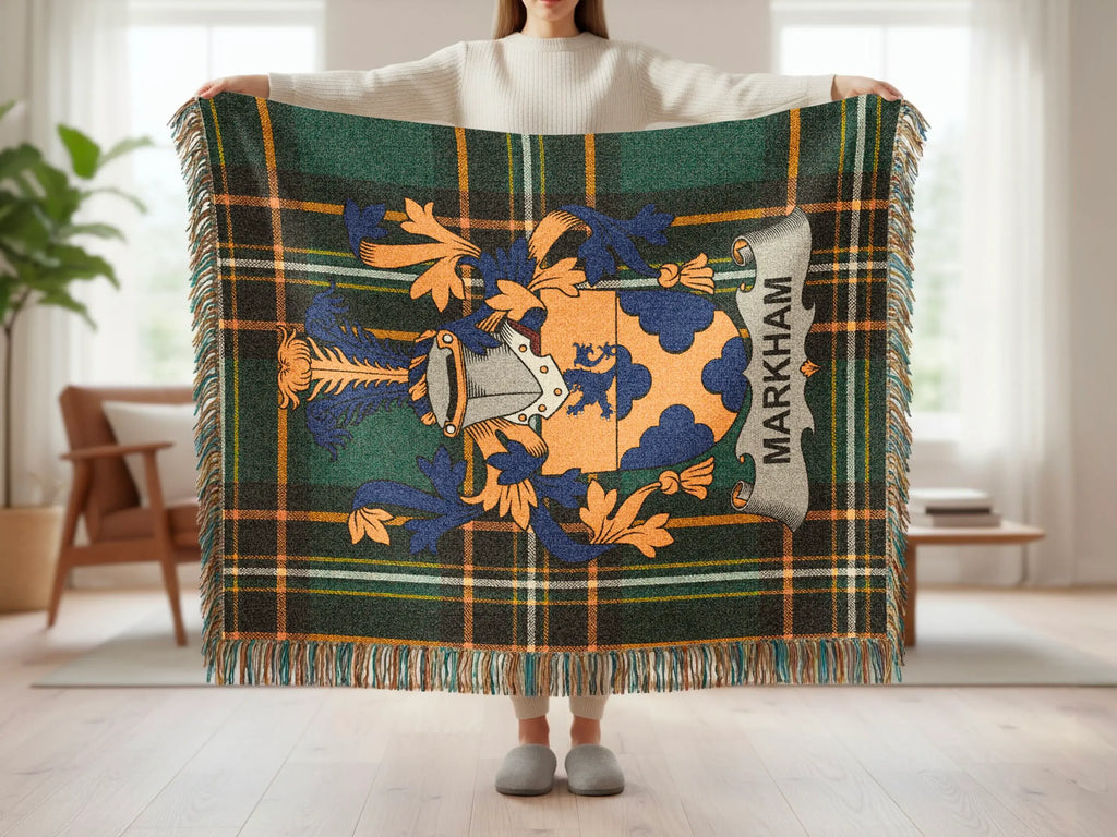 Tartan throw with a coat of arms and "MARKHAM" text.