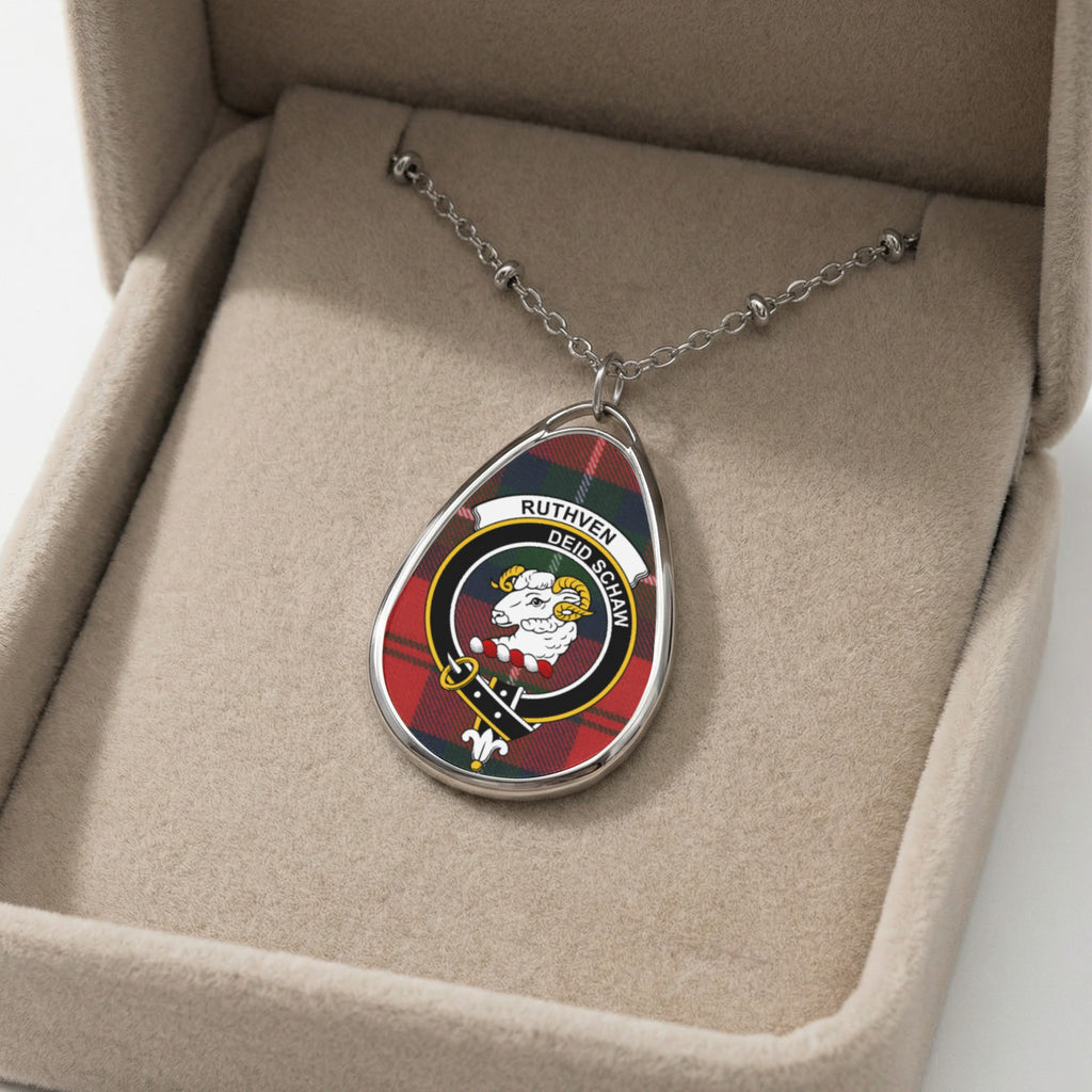 Oval pendant with Ruthven tartan and sheep crest in a jewelry box.