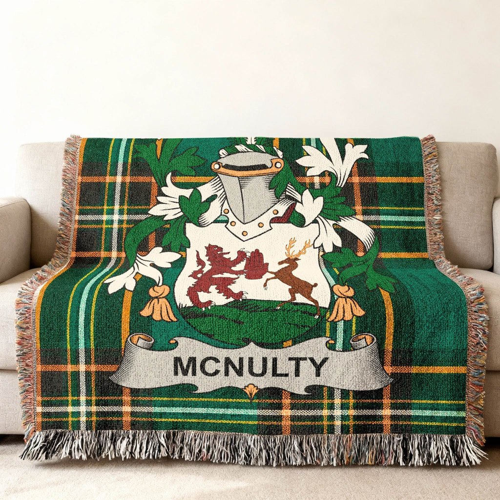 McNulty family crest on a green tartan blanket draped over a couch.
