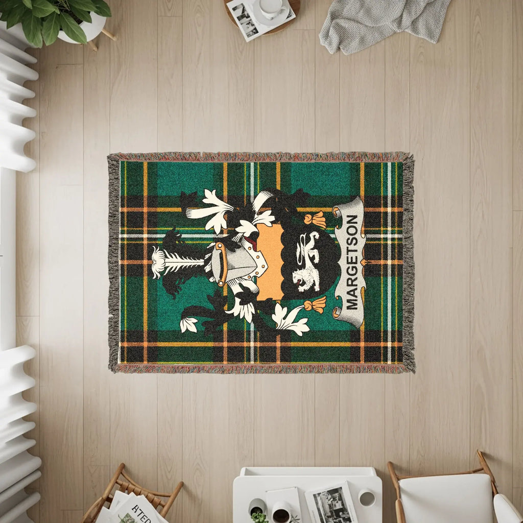 Tartan blanket with Margetson clan crest, draped over a floor.