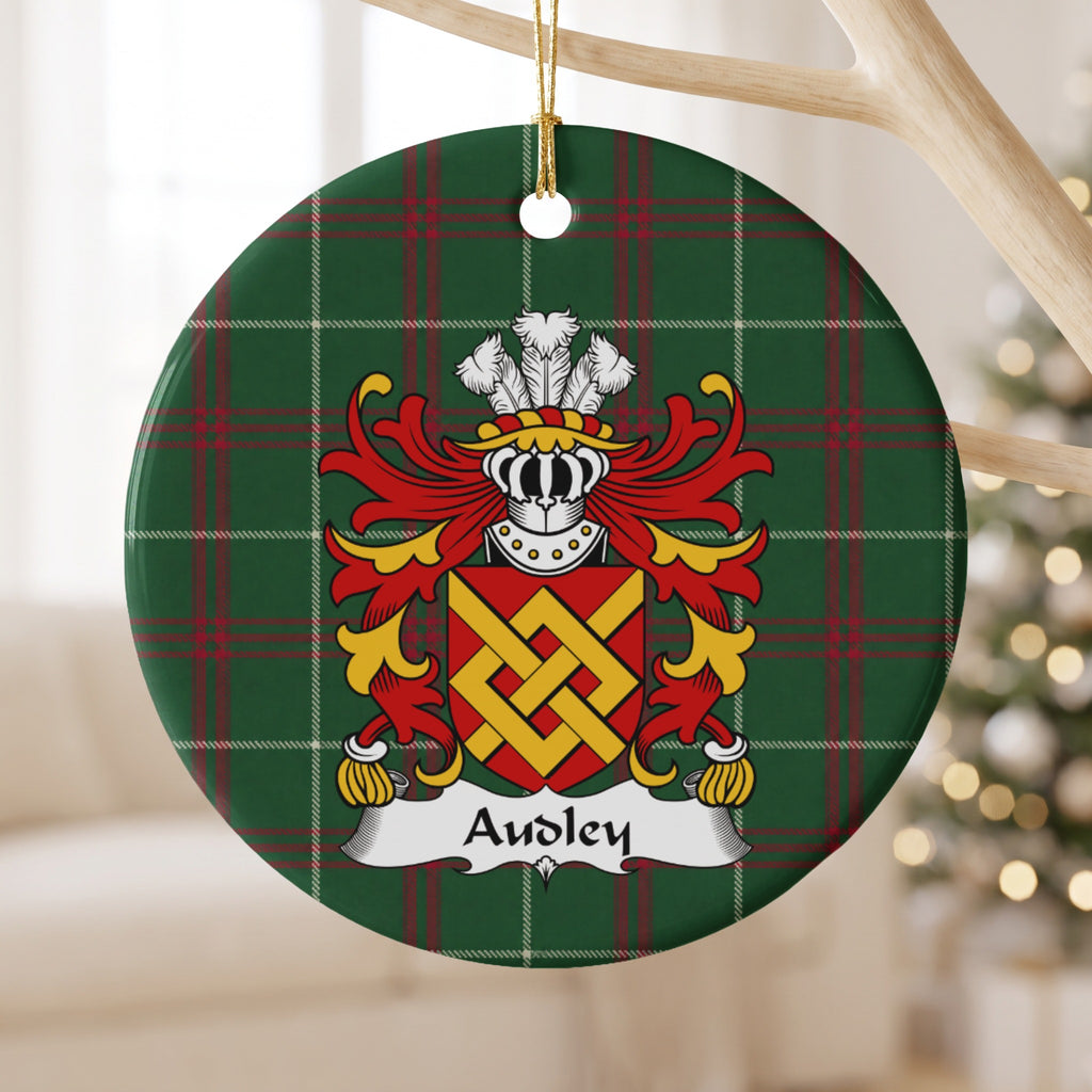 Audley ornament hanging from a pale branch; an interlaced gold fret on a red shield on Welsh national tartan.