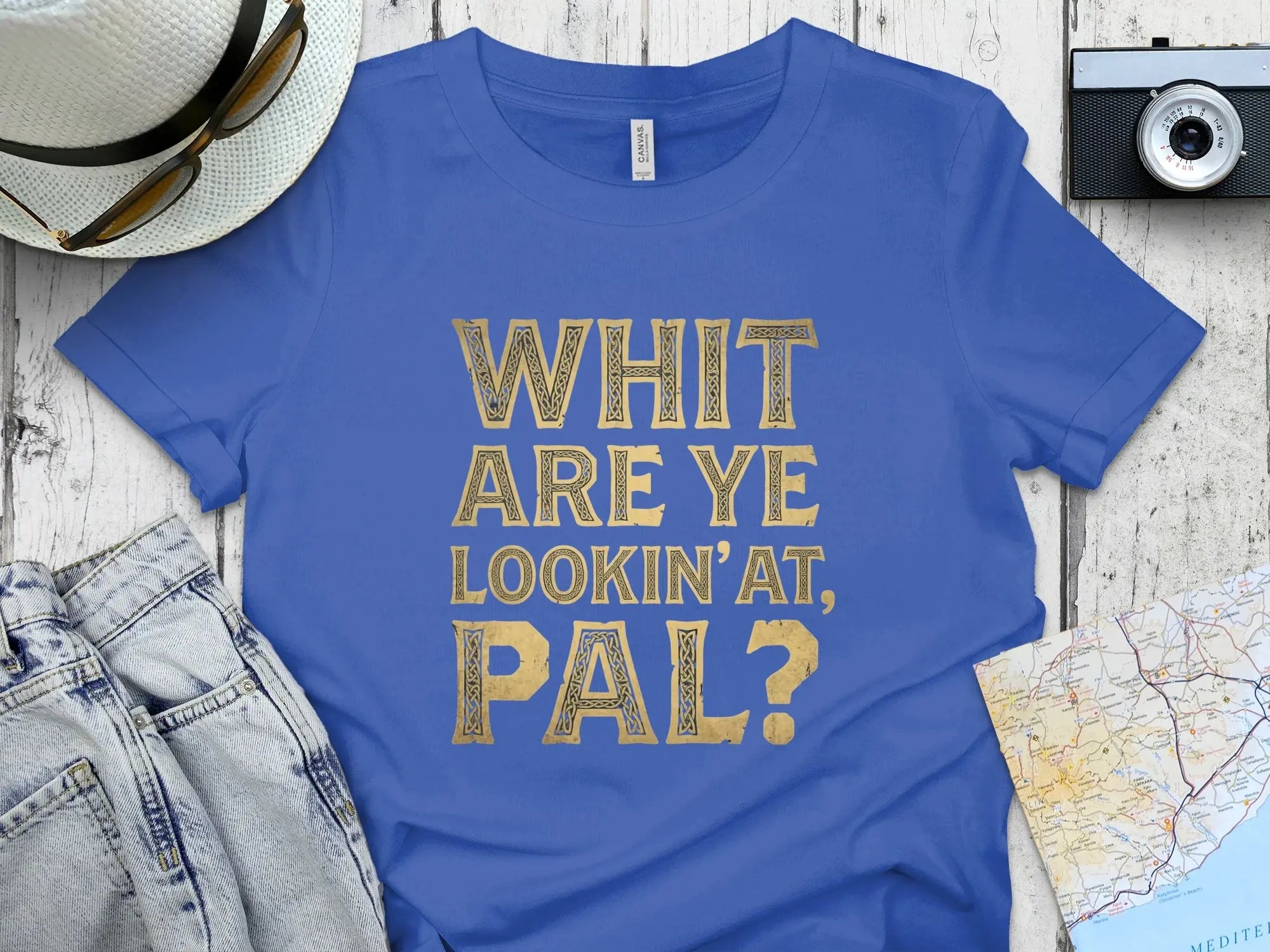 Royal blue t-shirt with gold text "WHIT ARE YE LOOKIN' AT, PAL?".