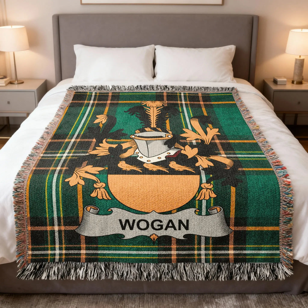 Wogan family crest on a green plaid woven blanket on a bed.