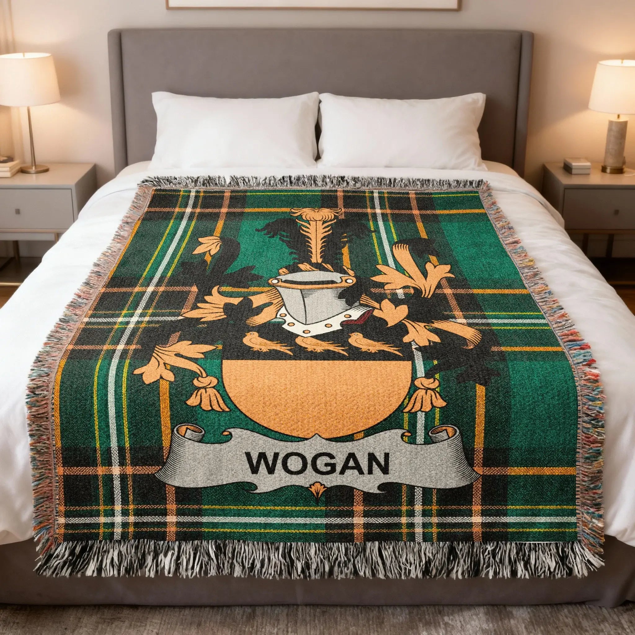 Wogan family crest on a green plaid woven blanket on a bed.