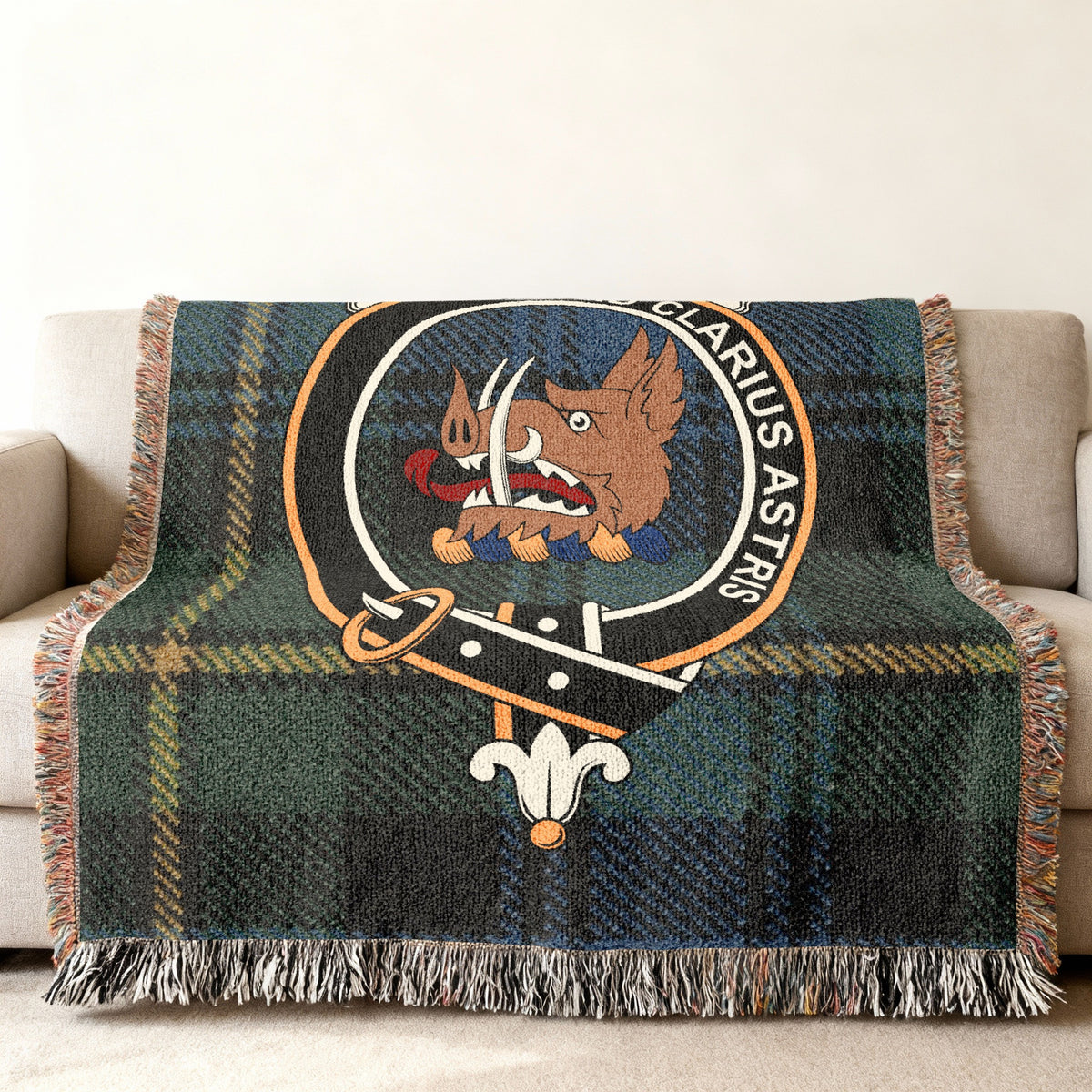 Close view of the Baillie woven blanket draped over a sofa, showing the crest and fringed edges