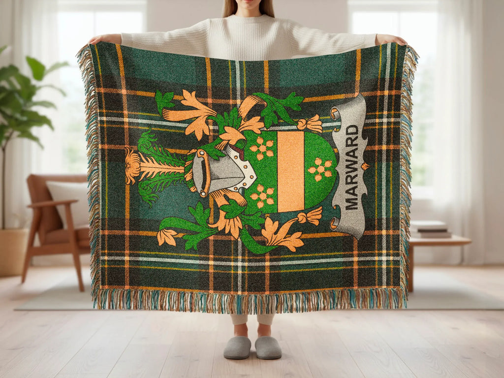 Green plaid blanket with Marward family crest and decorative fringe.