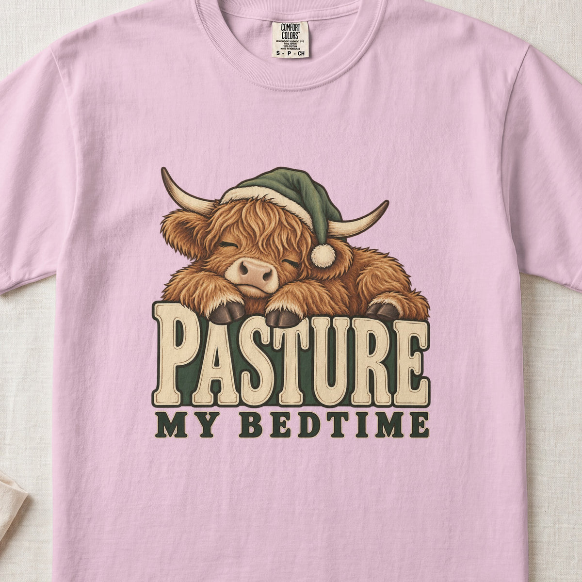 Pasture My Bedtime Highland cow design on a Blossom Comfort Colors 1717 T-shirt, flat lay