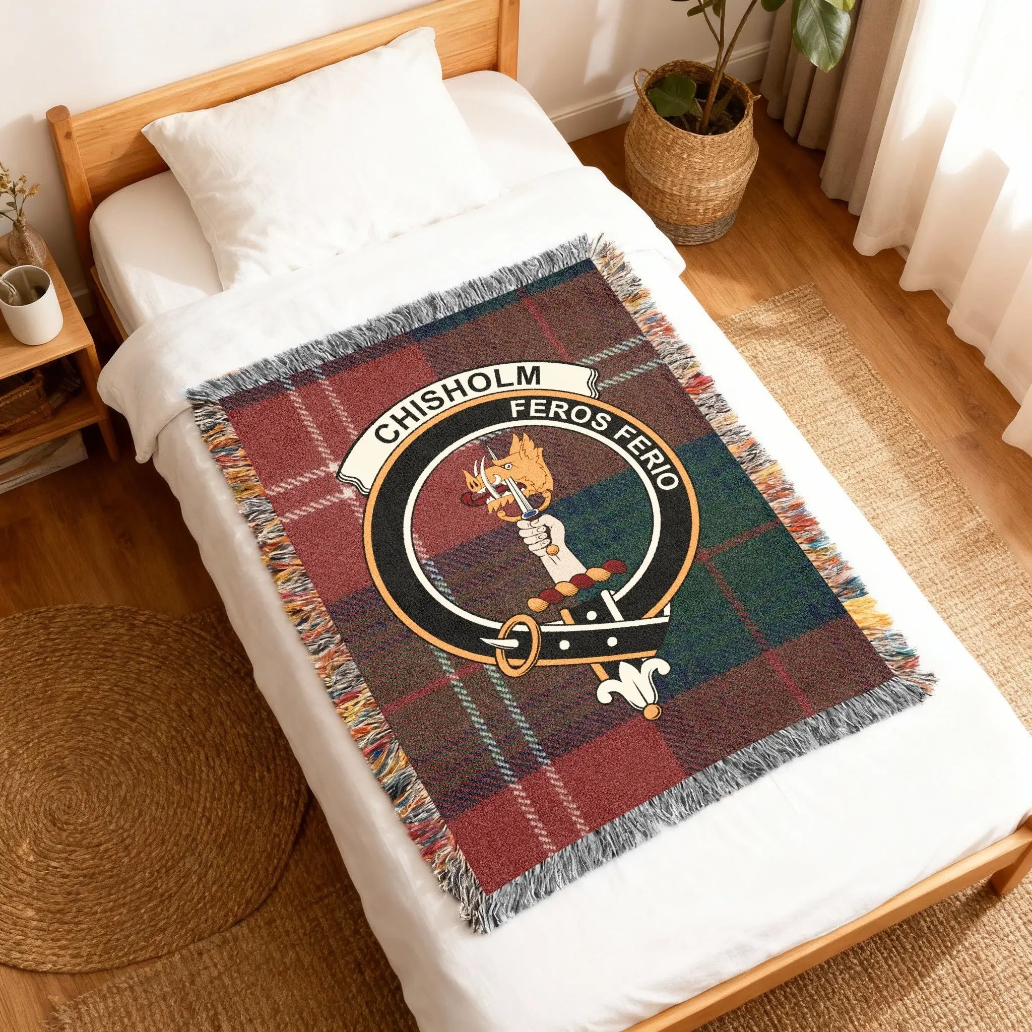 Chisholm Feros Ferio tartan woven blanket folded — green and red plaid weave with clan crest