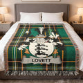 Plaid throw blanket featuring a coat of arms with the name "LOVETT" centered.