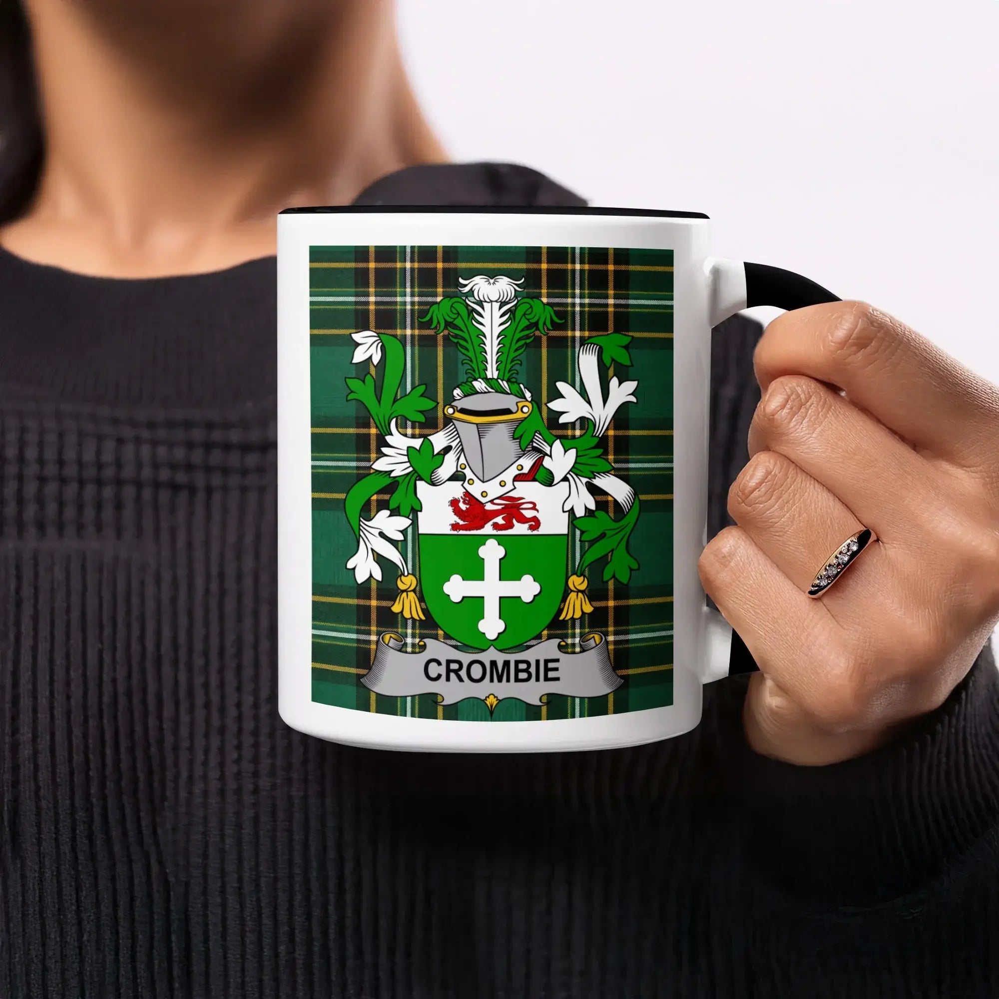 White mug with black handle displaying the Crombie coat of arms on green plaid.