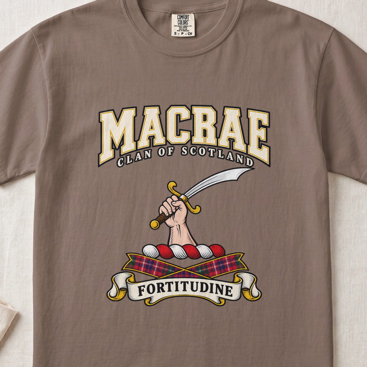 MacRae graphic T-shirt in Espresso brown, front flat lay showing varsity lettering and hand and forearm holding a curved silver sword with a gold hilt.