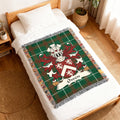 Woven blanket with green tartan and the Owen family crest.